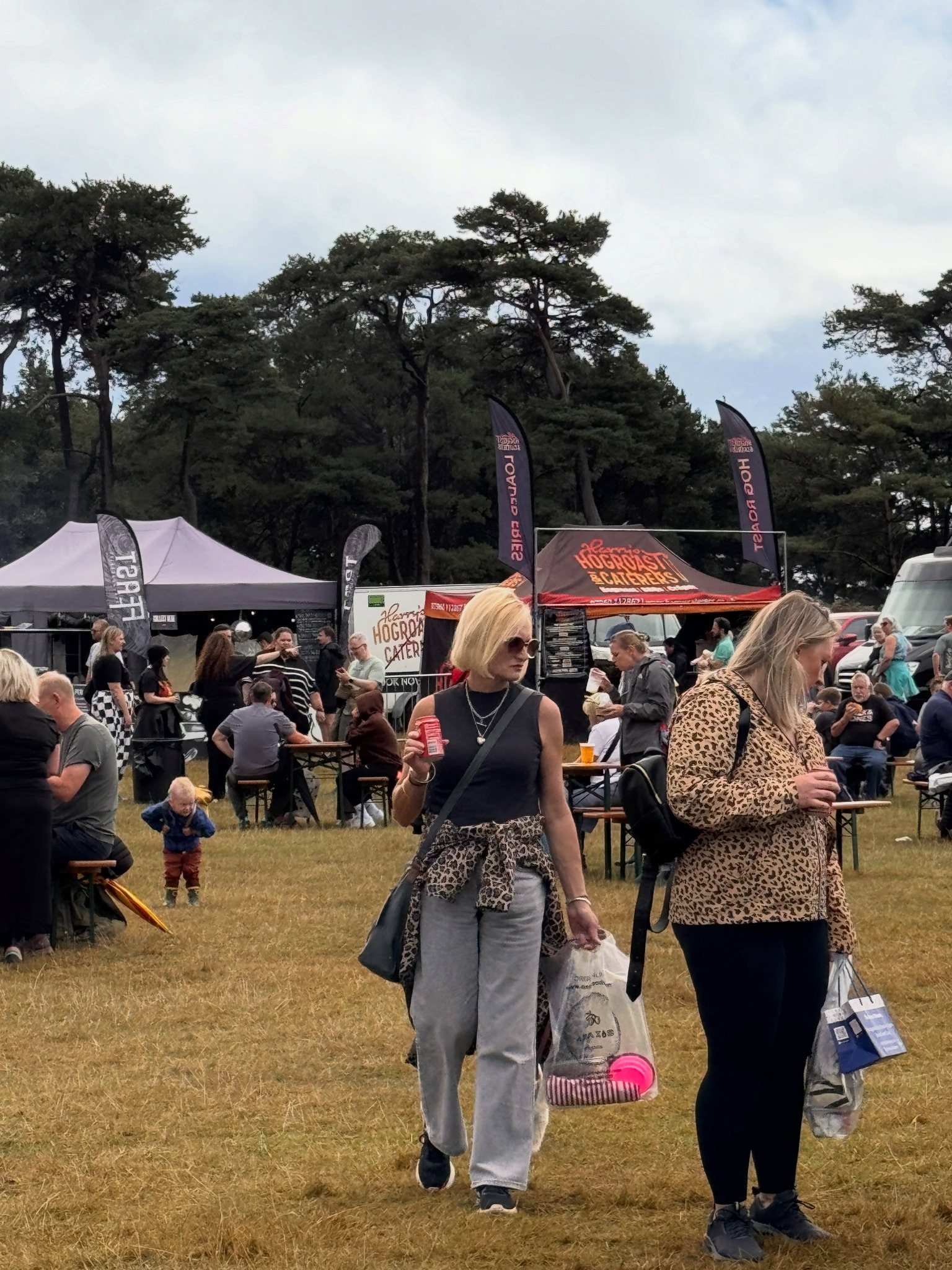 Visitors walking between outdoor stalls